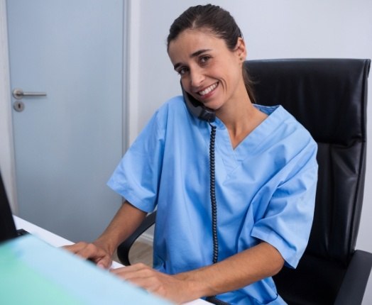 Friendly Harker Heights dental team member answering the phone