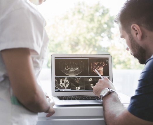 Dentist looking at smile images during an oral cancer screening visit