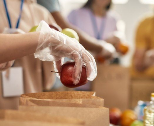 Volunteers putting food donations in bags