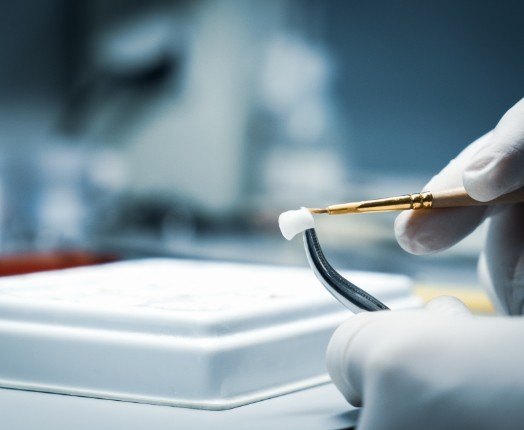 Dentist crafting custom dental crown restoration