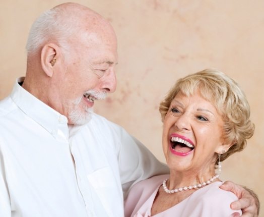 Smiling mand and woman with dentures