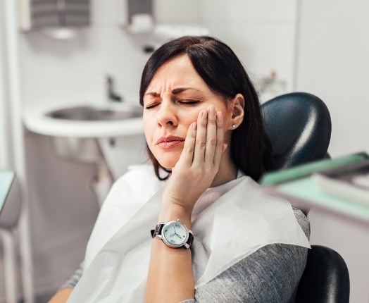 Woman in pain before treatment from her emergency dentist in Harker Heights Texas