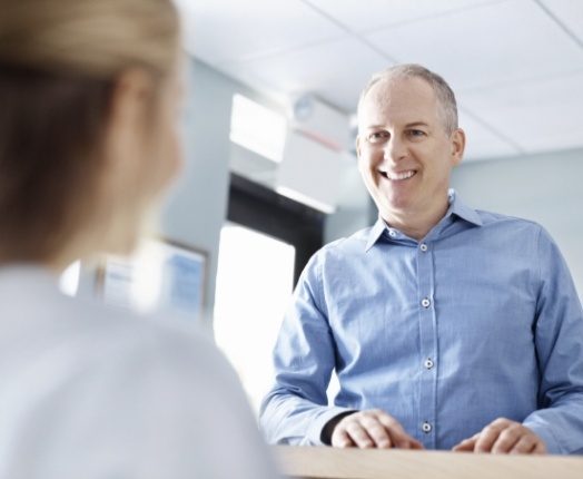 Man checking in for emergency dentistry visit