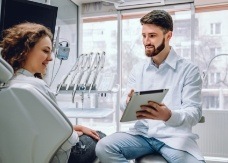 Dentist and dentistry patient in modern dental office