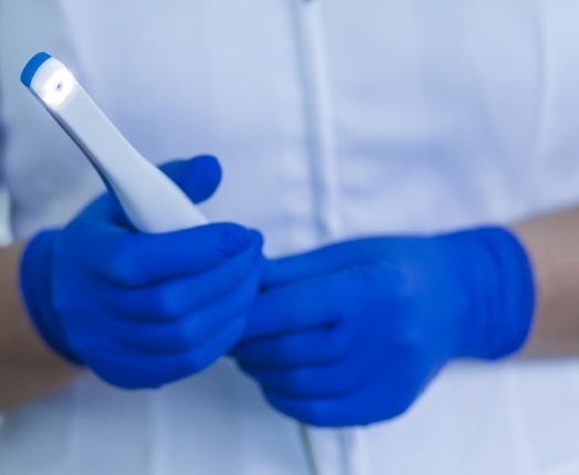 Dentist holding an intraoral camera