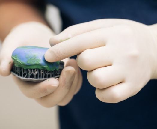 Dentist crafting a wax up smile model