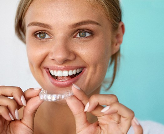 A dentist assessing a man’s smile for teeth whitening