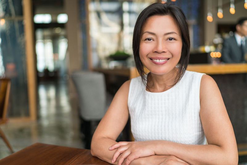 Happy elegant Asian middle-aged businesswoman smiling portrait