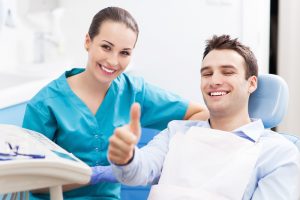 Man giving thumbs up at dentist office