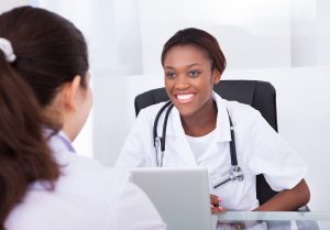 woman seated consulting with dentist 