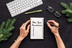 woman writing her New Year’s resolutions