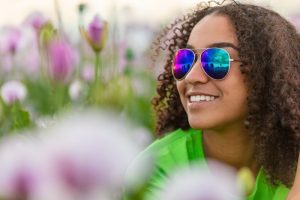 Woman with sunglasses smiles after visiting Harker Heights