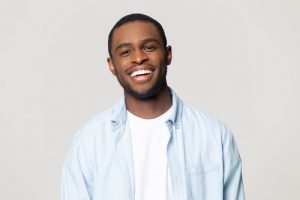 man smiling after investing tax refund in his dental health 