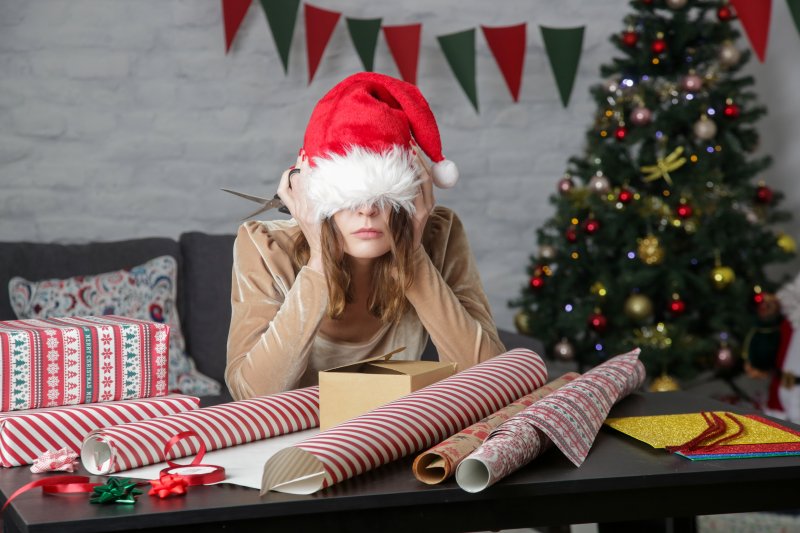 A stressed woman sitting in a festive setting